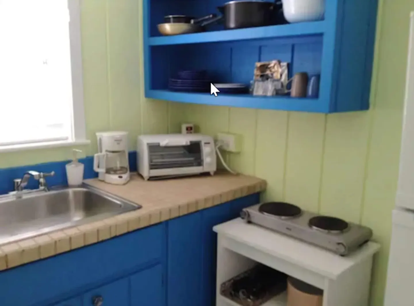 Superior Suite kitchenette with sink, toaster oven, coffee maker, and cooktop at St John Inn.