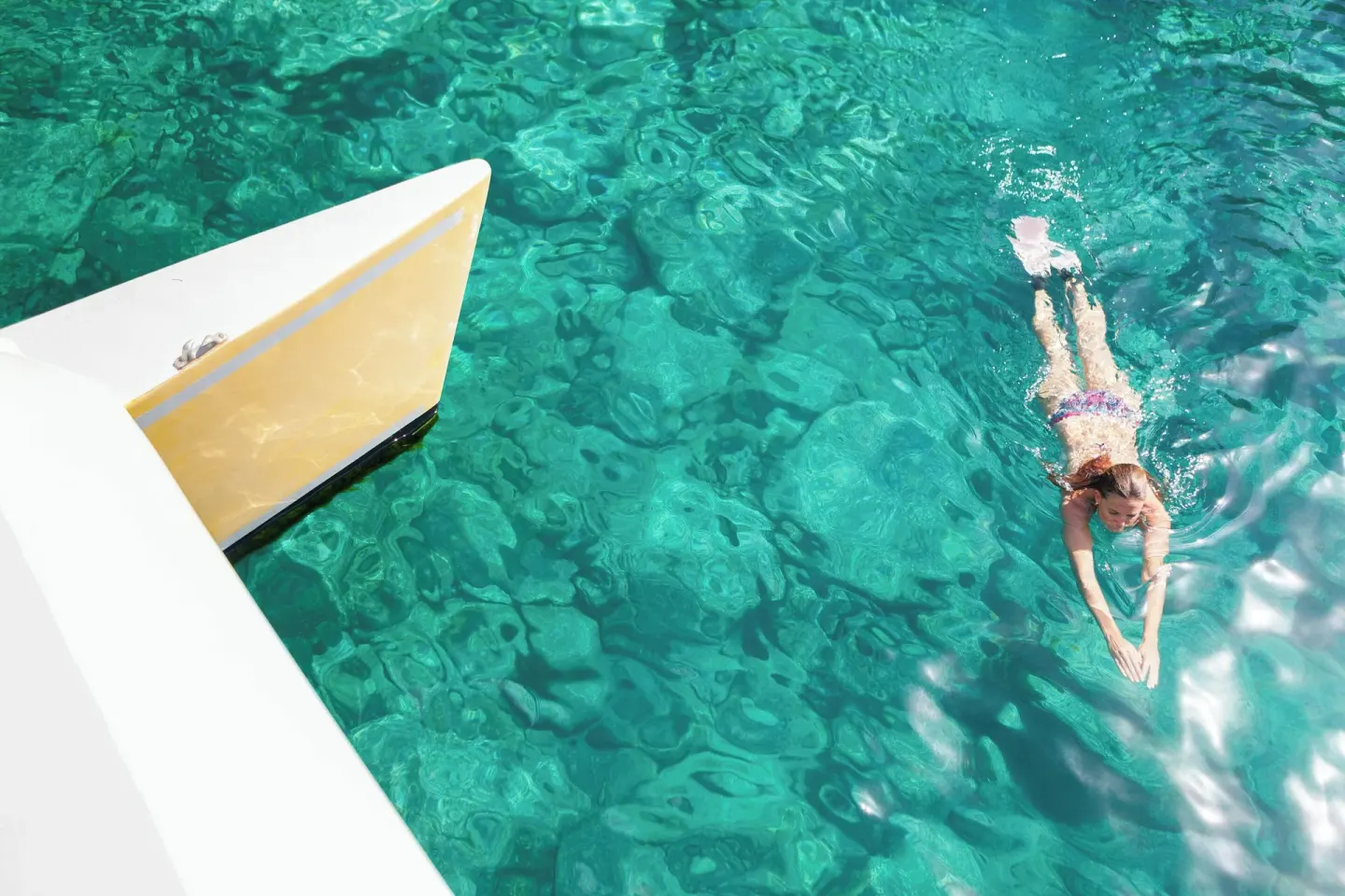 A swimmer in clear turquoise water near St Kitts Marriott Beach Resort, Casino & Spa.