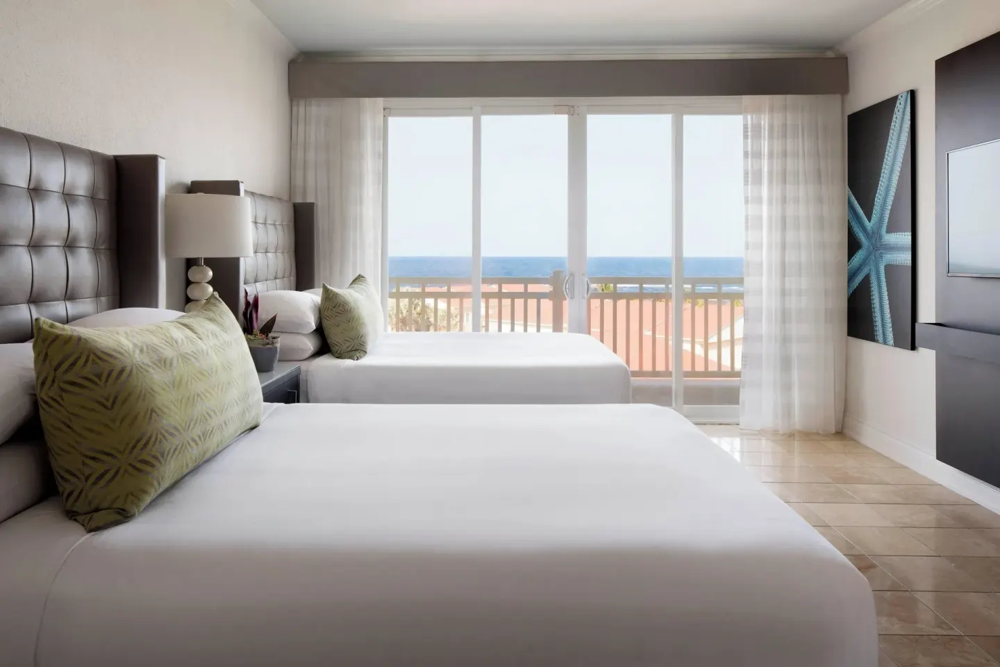 Presidential Suite bedroom with two beds and ocean-facing balcony at St Kitts Marriott Beach Resort, Casino & Spa.