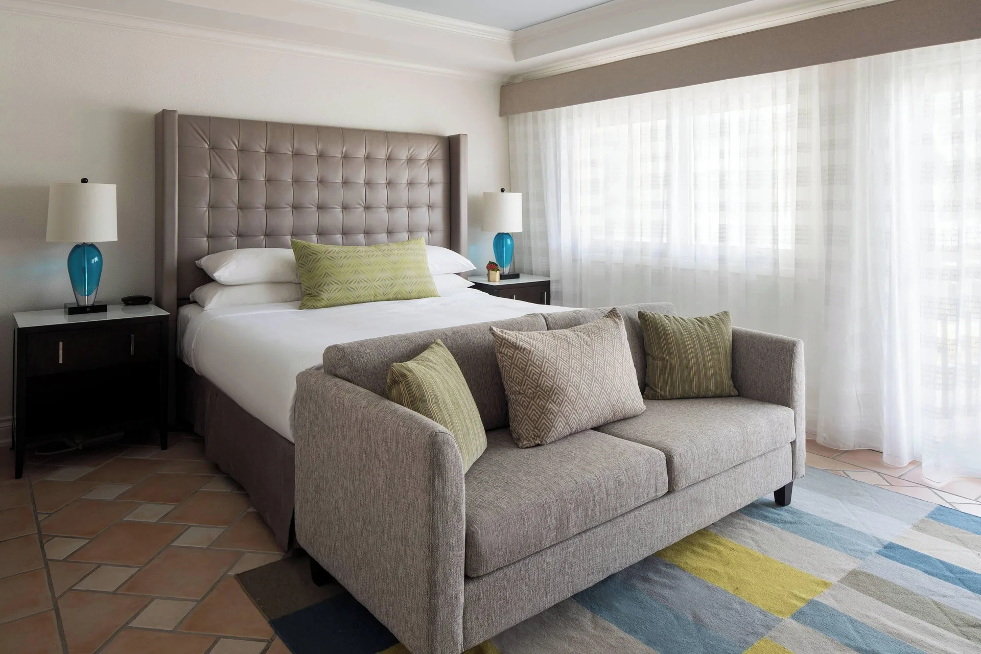 Bedroom with king bed and sofa in a villa at St Kitts Marriott Beach Resort, Casino & Spa.