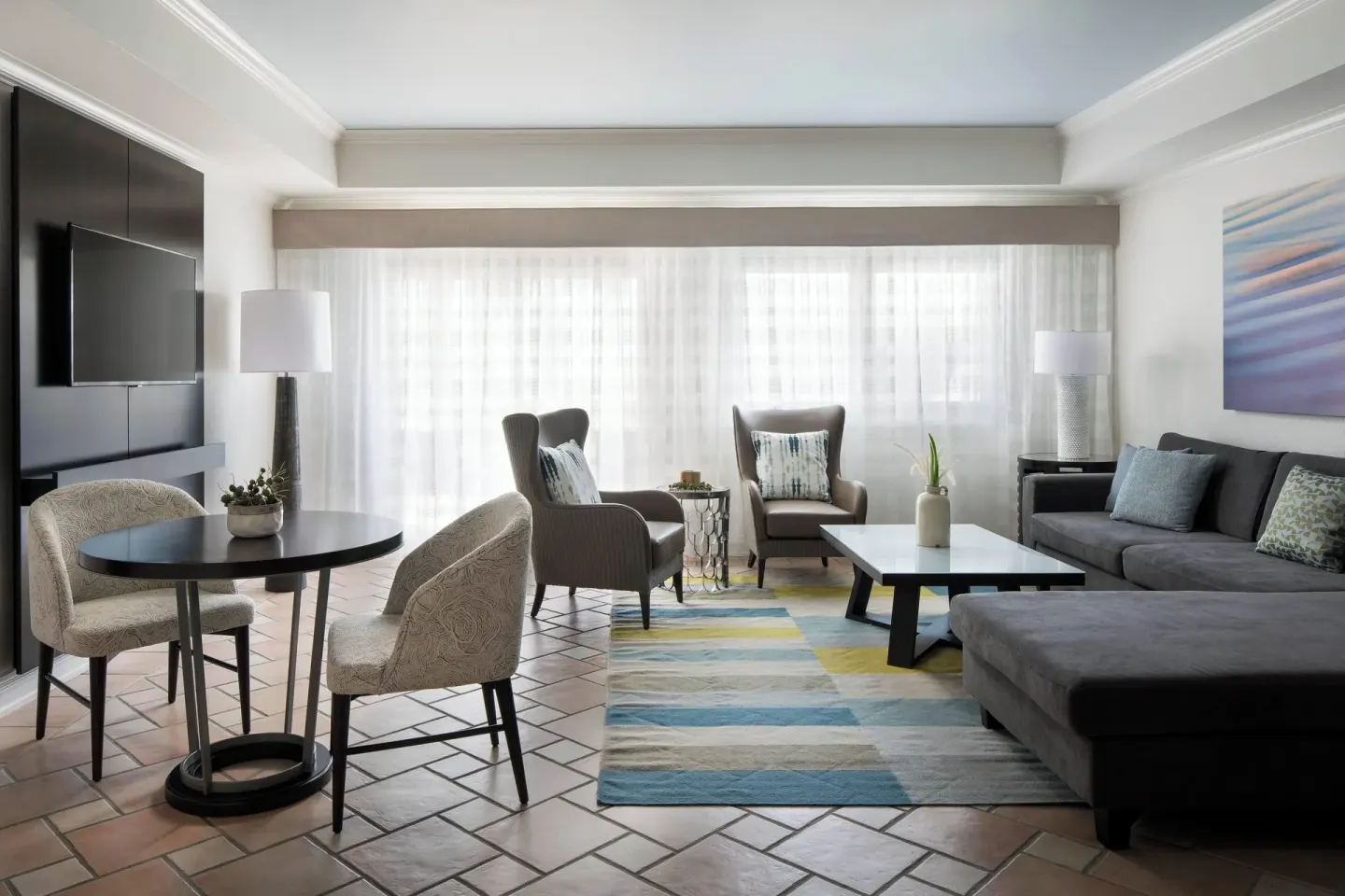 Living room with dining table and sectional in a villa at St Kitts Marriott Beach Resort, Casino & Spa.