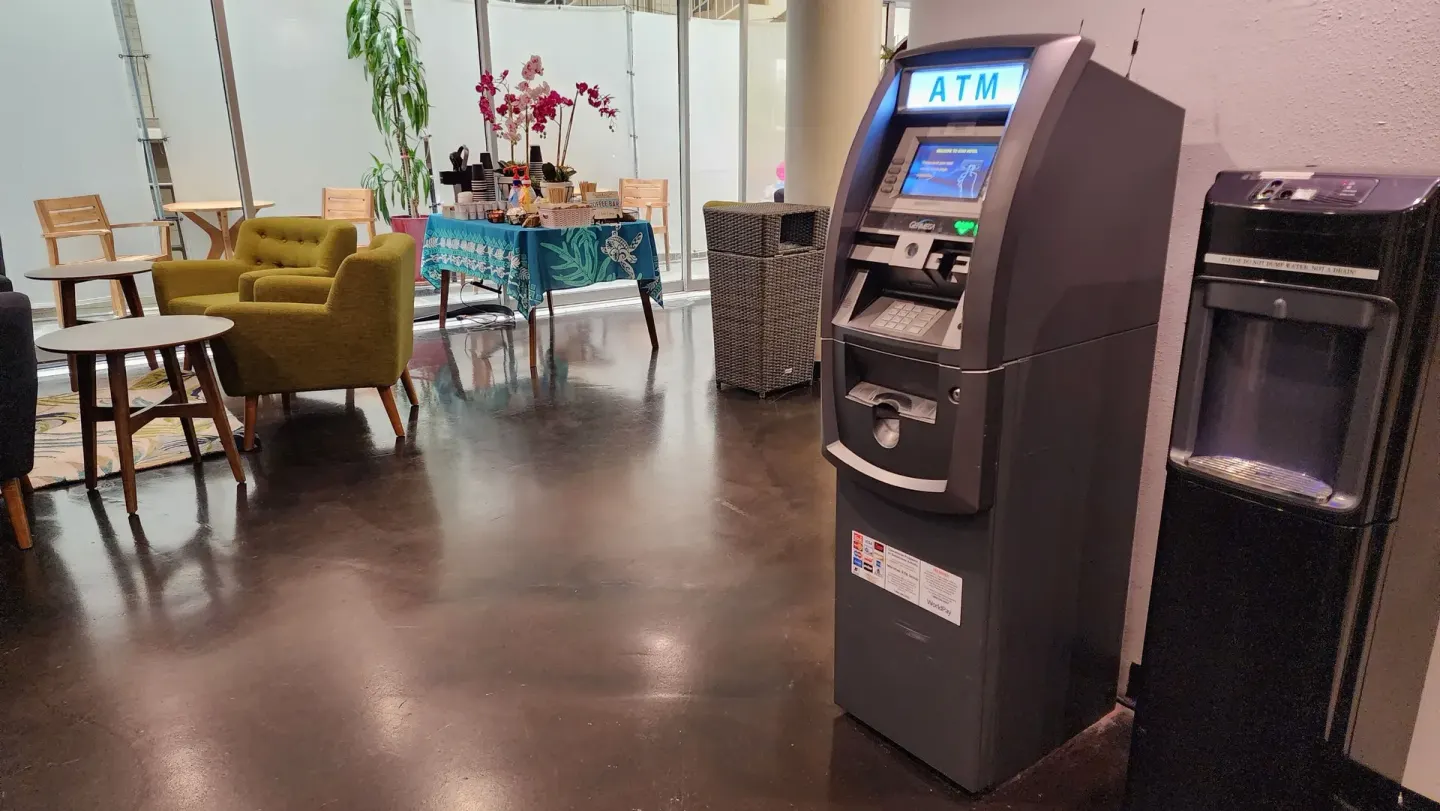 ATM and water fountain beside lobby seating at Stay Hotel Waikiki.