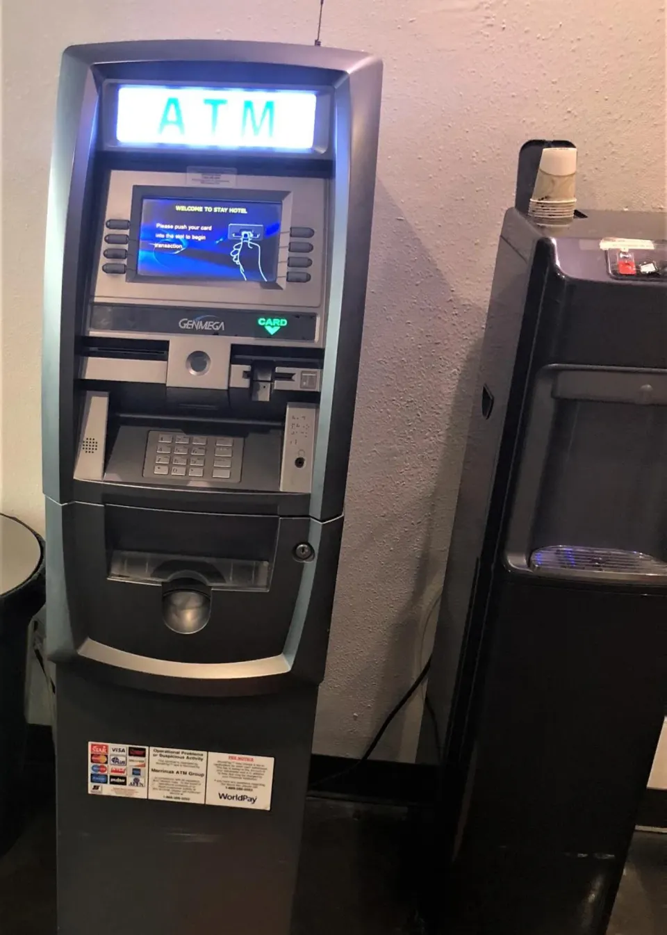 ATM and water dispenser against an interior wall at Stay Hotel Waikiki.