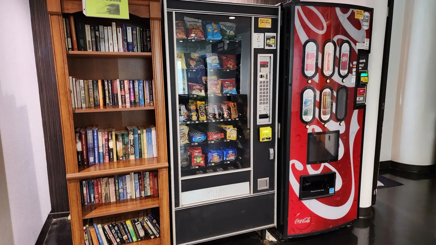 Bookshelves and snack and drink vending machines at Stay Hotel Waikiki.