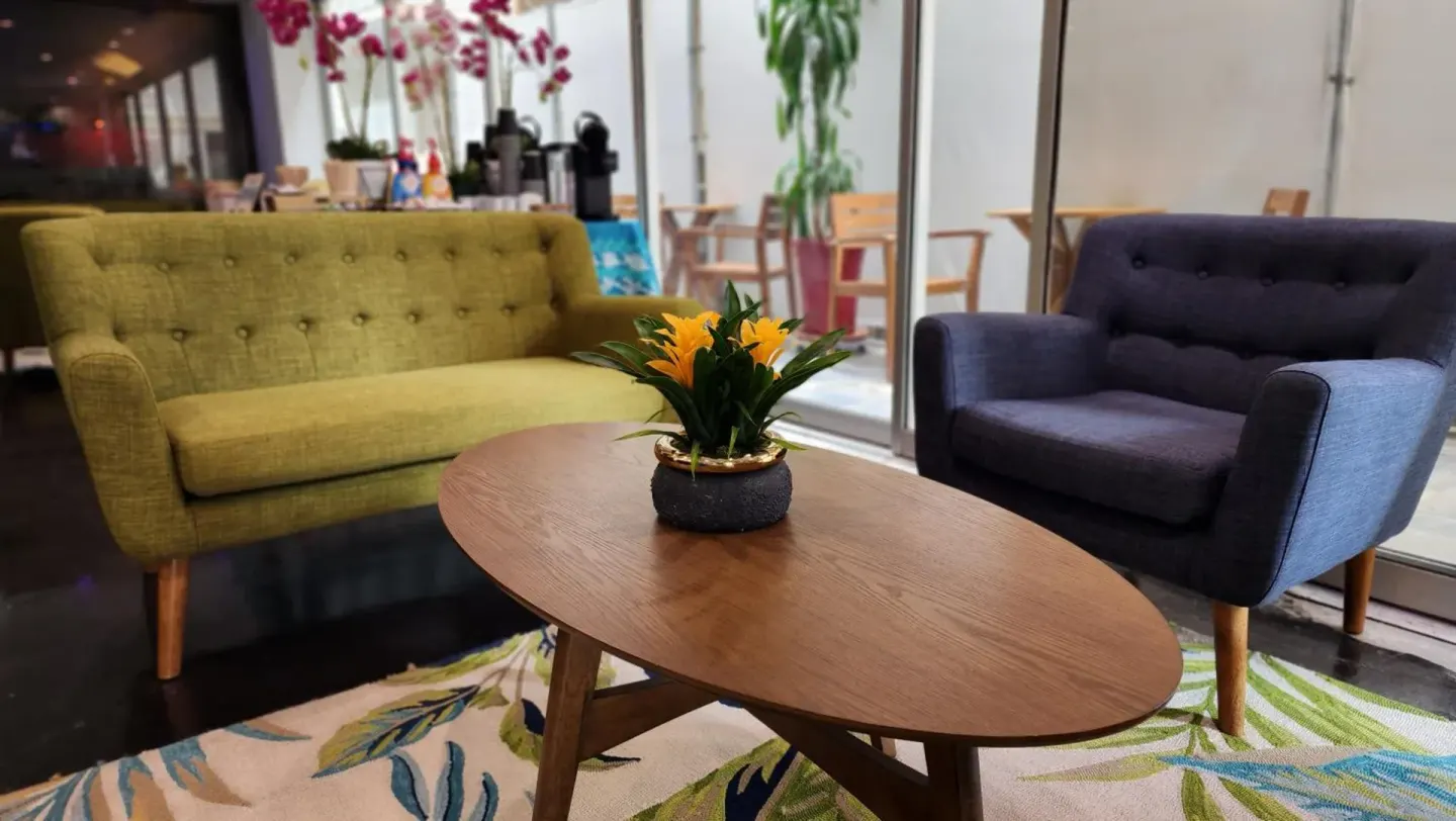 Lobby lounge seating with a coffee table at Stay Hotel Waikiki.
