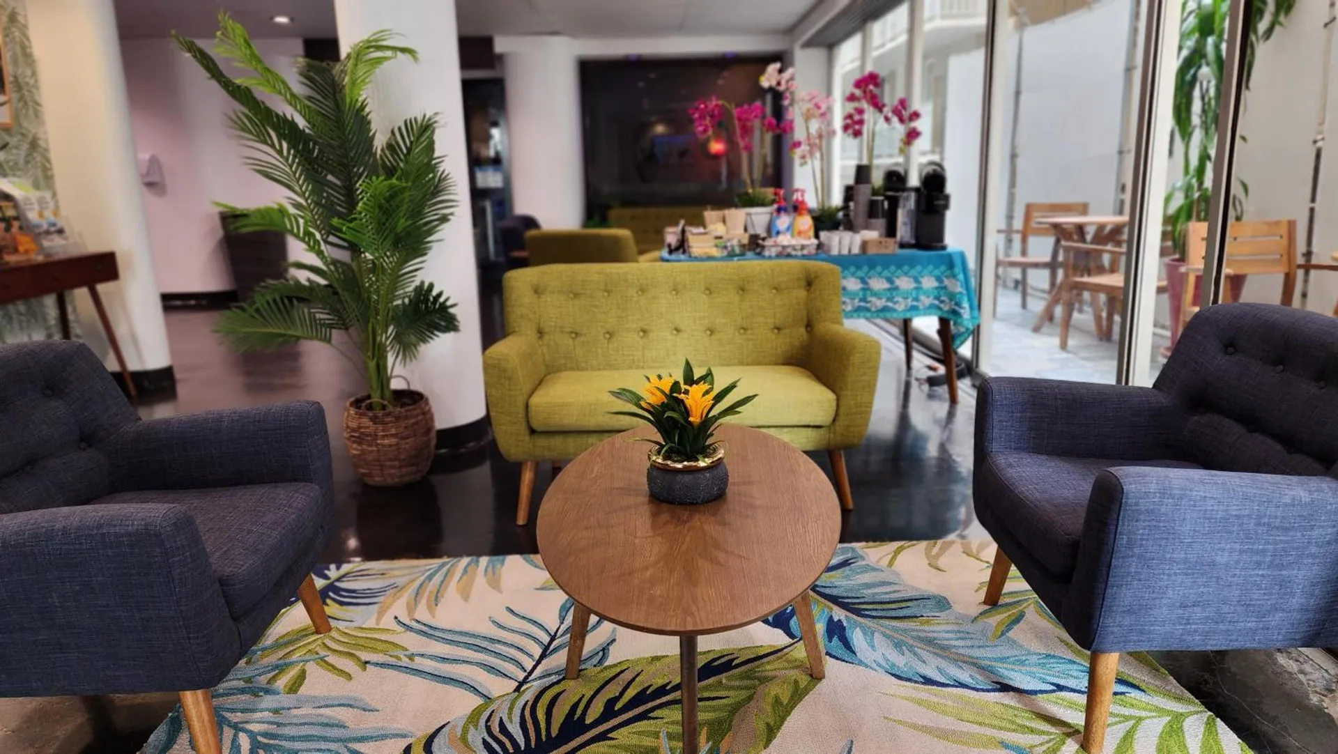 Lobby seating with colorful chairs and tropical rug at Stay Hotel Waikiki.