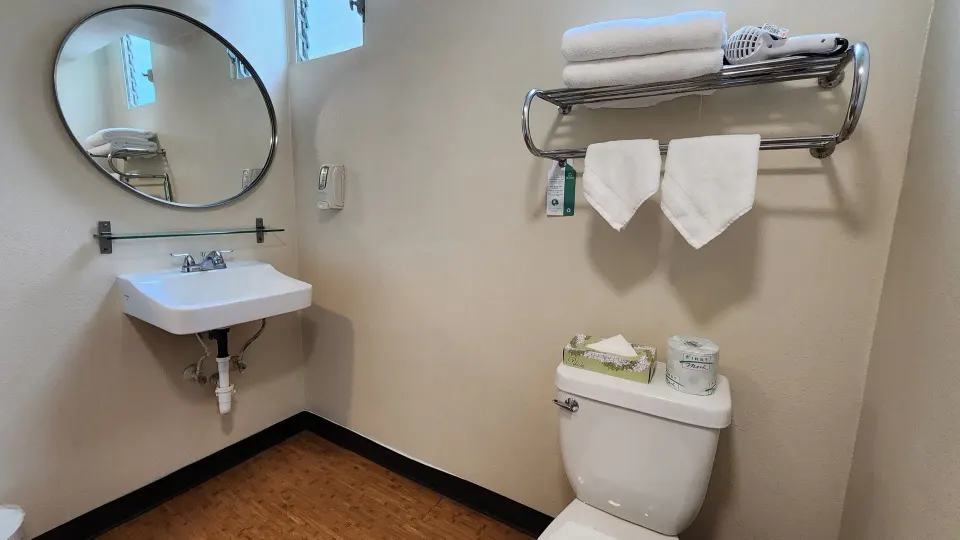 2 Twins Beds Room bathroom vanity, toilet, towel rack, and round mirror at Stay Hotel Waikiki.