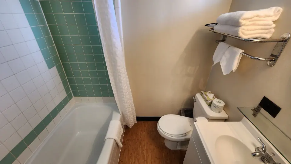 Boutique Room bathroom with tub, toilet, sink and towels at Stay Hotel Waikiki.