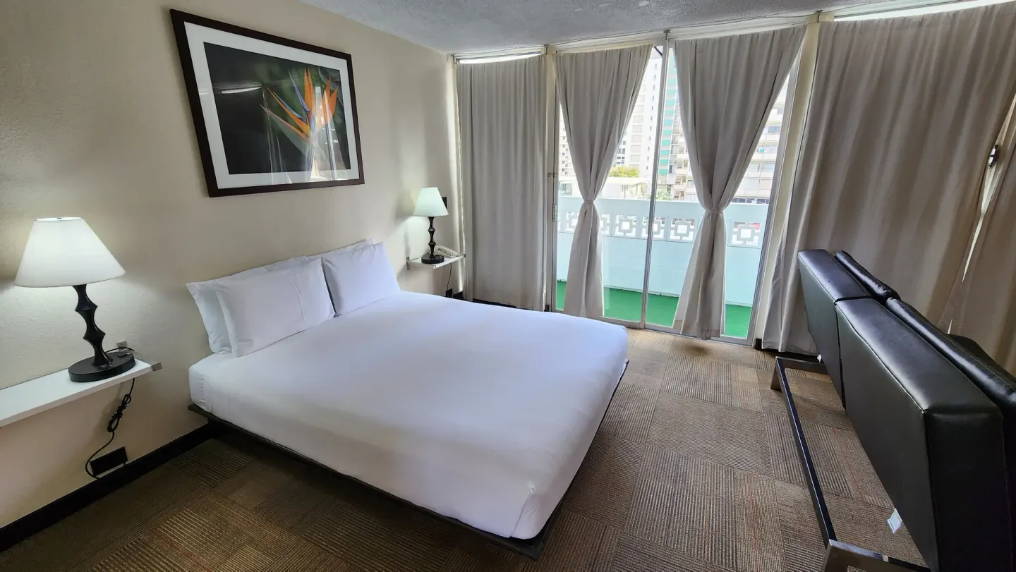 Deluxe Room with king bed, sofa bed and balcony doors at Stay Hotel Waikiki.