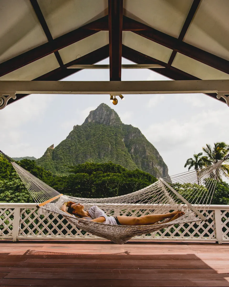 Guest relaxing in a hammock with Piton views at Stonefield Villa Resort.