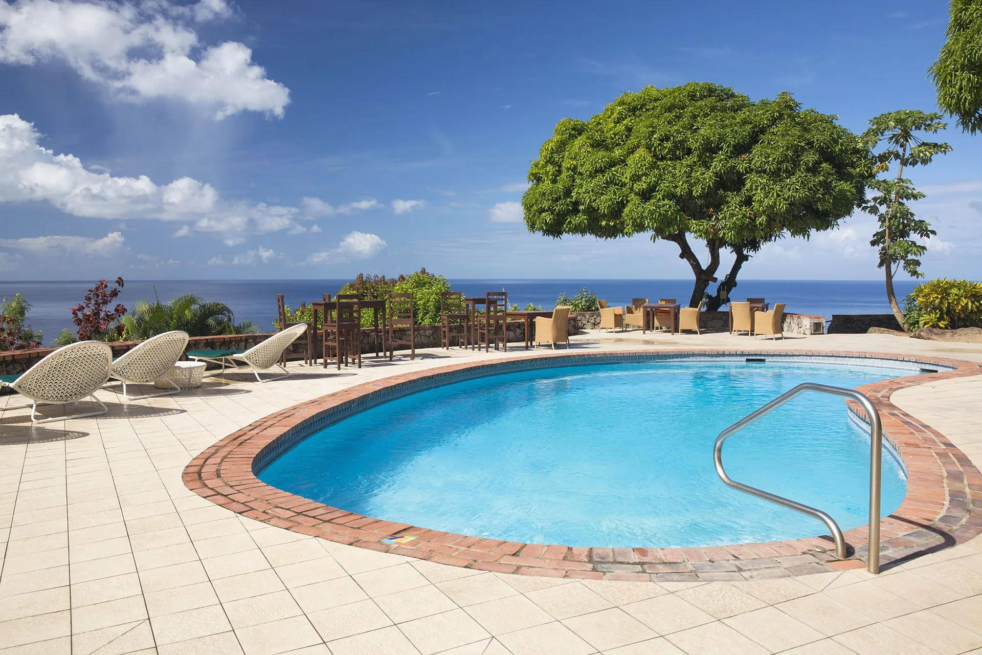 Swimming pool terrace with ocean view at Stonefield Villa Resort.
