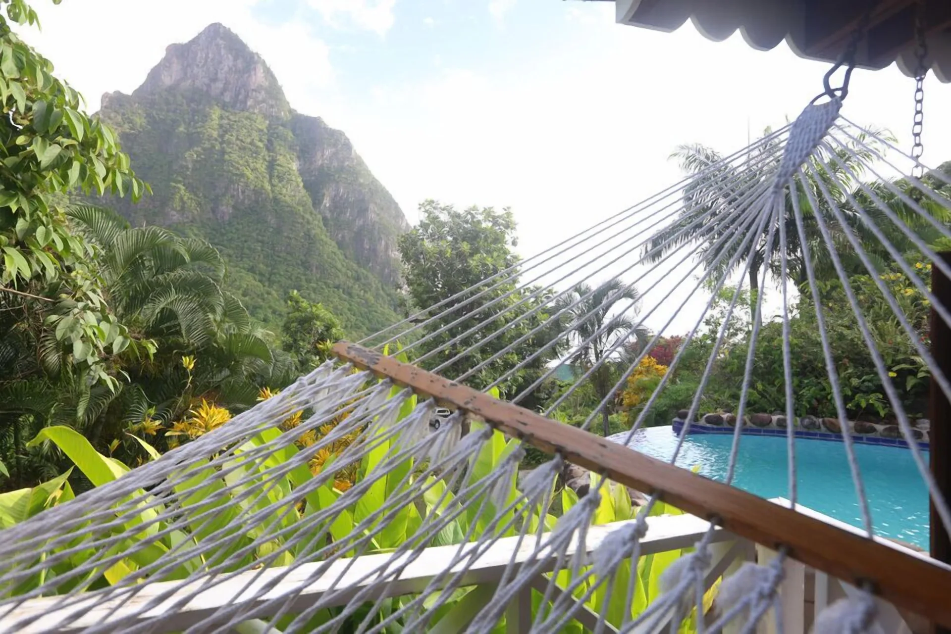 Rope hammock beside a pool with Piton views at Stonefield Villa Resort.
