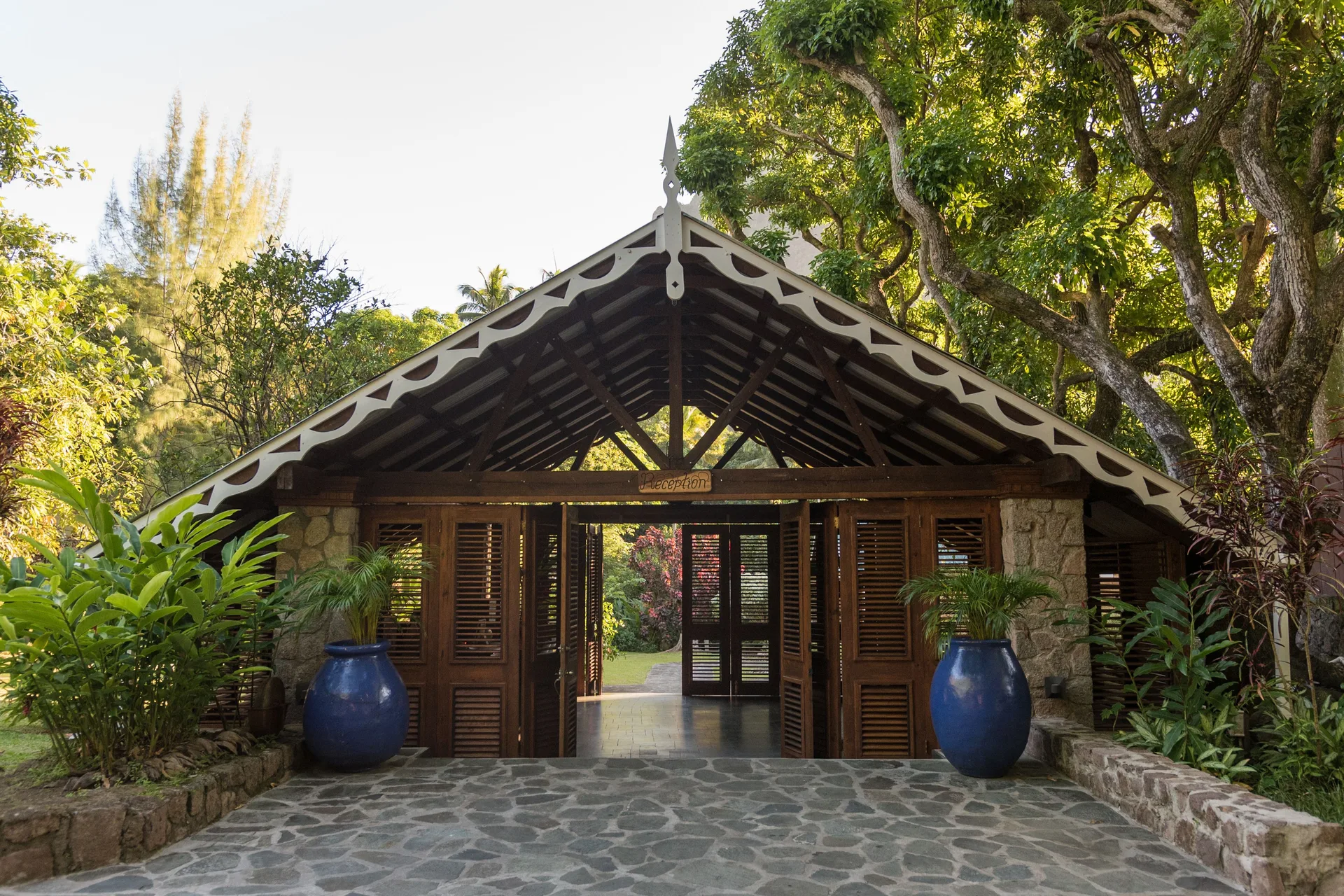 Reception entrance with stone walls and tropical gardens at Stonefield Villa Resort.