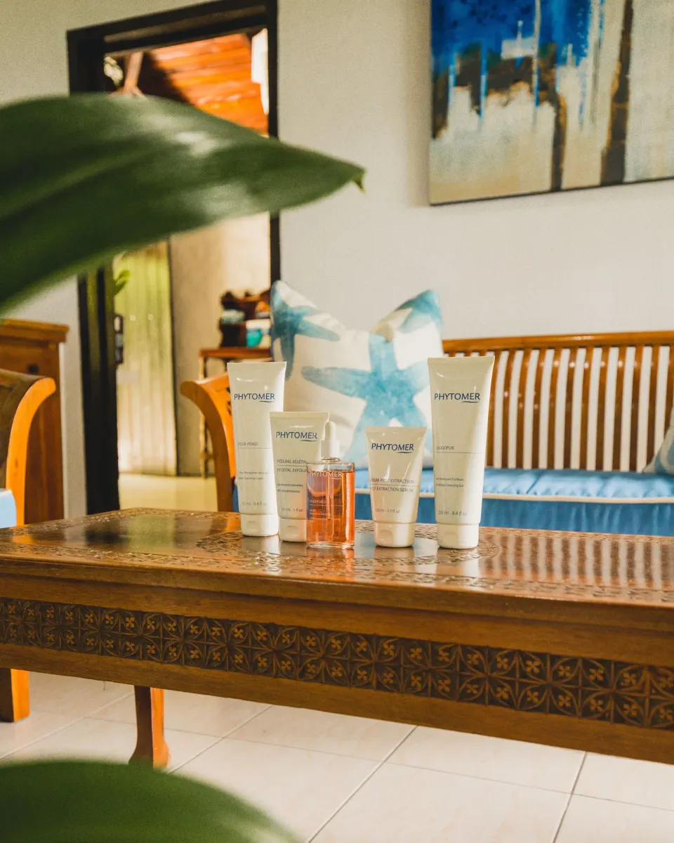 Spa skincare products displayed on a carved table at Stonefield Villa Resort.