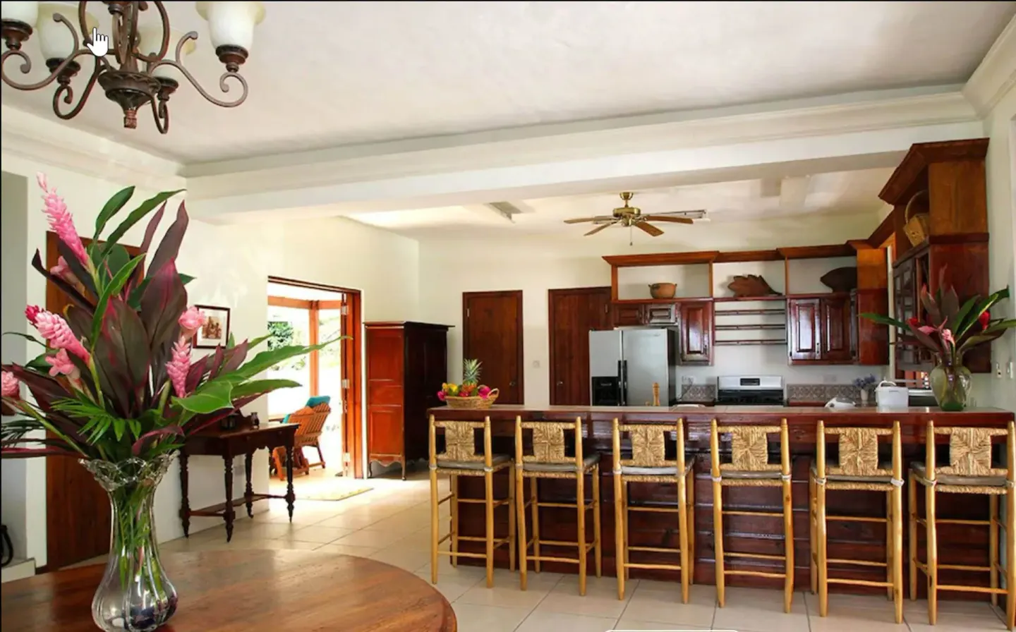 Open kitchen with breakfast bar and tropical flowers at Stonefield Villa Resort.