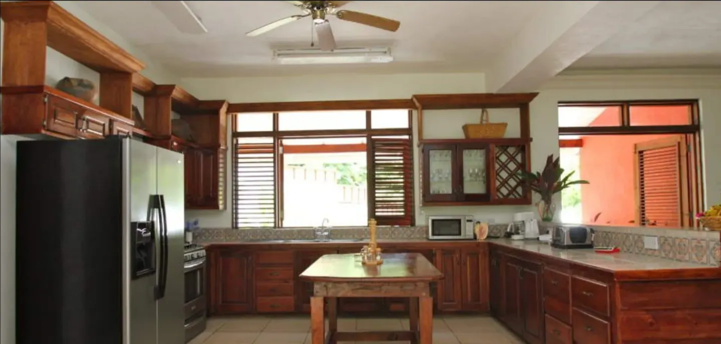 Full kitchen with wood cabinetry and island at Stonefield Villa Resort.