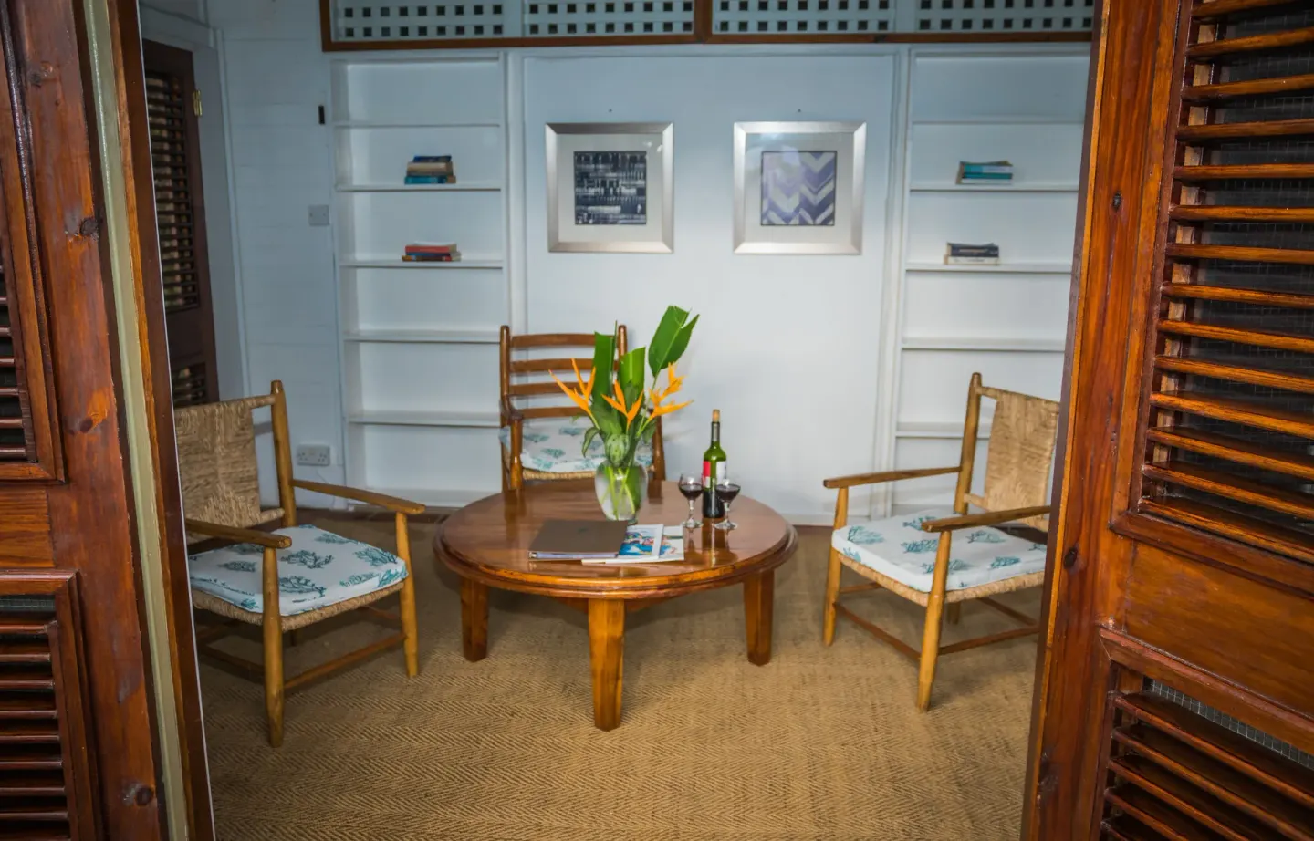 Small sitting room with wicker chairs and round table at Stonefield Villa Resort.