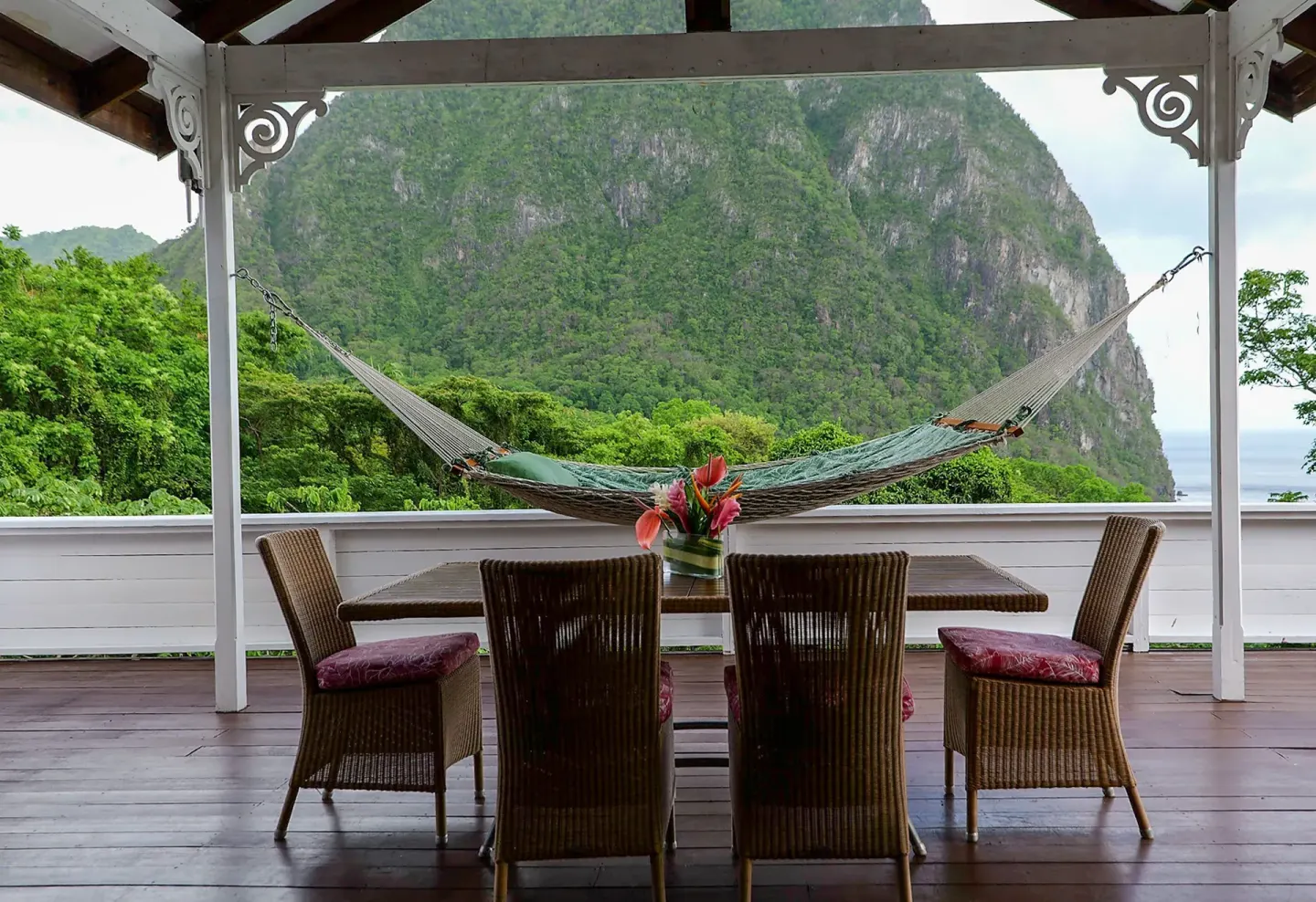 Covered terrace dining table and hammock in a Piton Ocean View Villa at Stonefield Villa Resort.