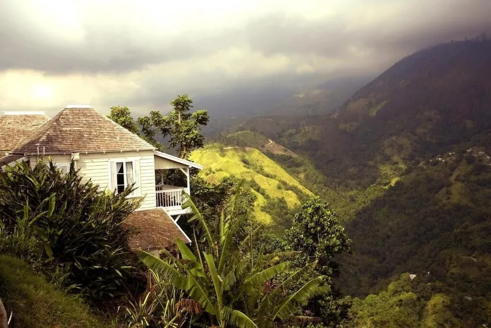 White hillside cottage and misty mountain valley at Strawberry Hill.