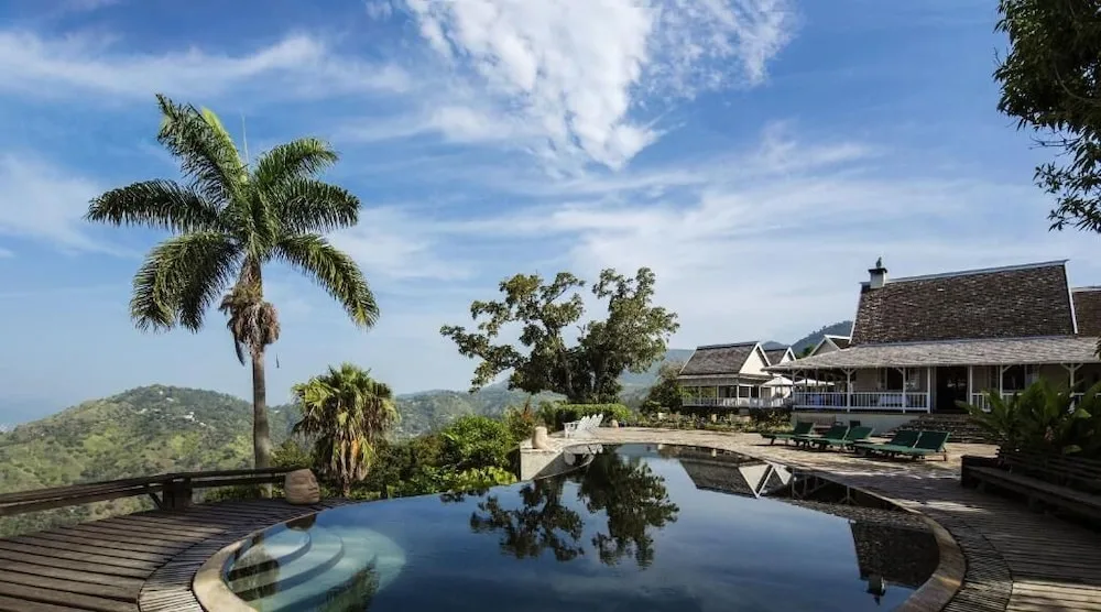 An infinity pool with mountain views and lounge chairs at Strawberry Hill.