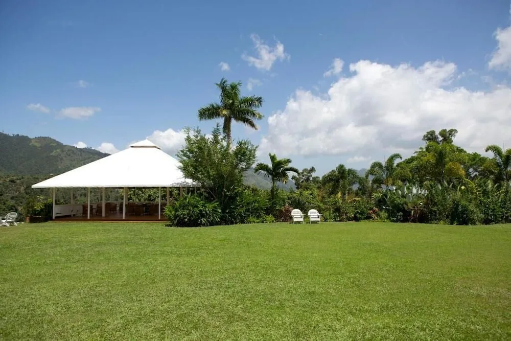 Open lawn with pavilion and mountain backdrop at Strawberry Hill.