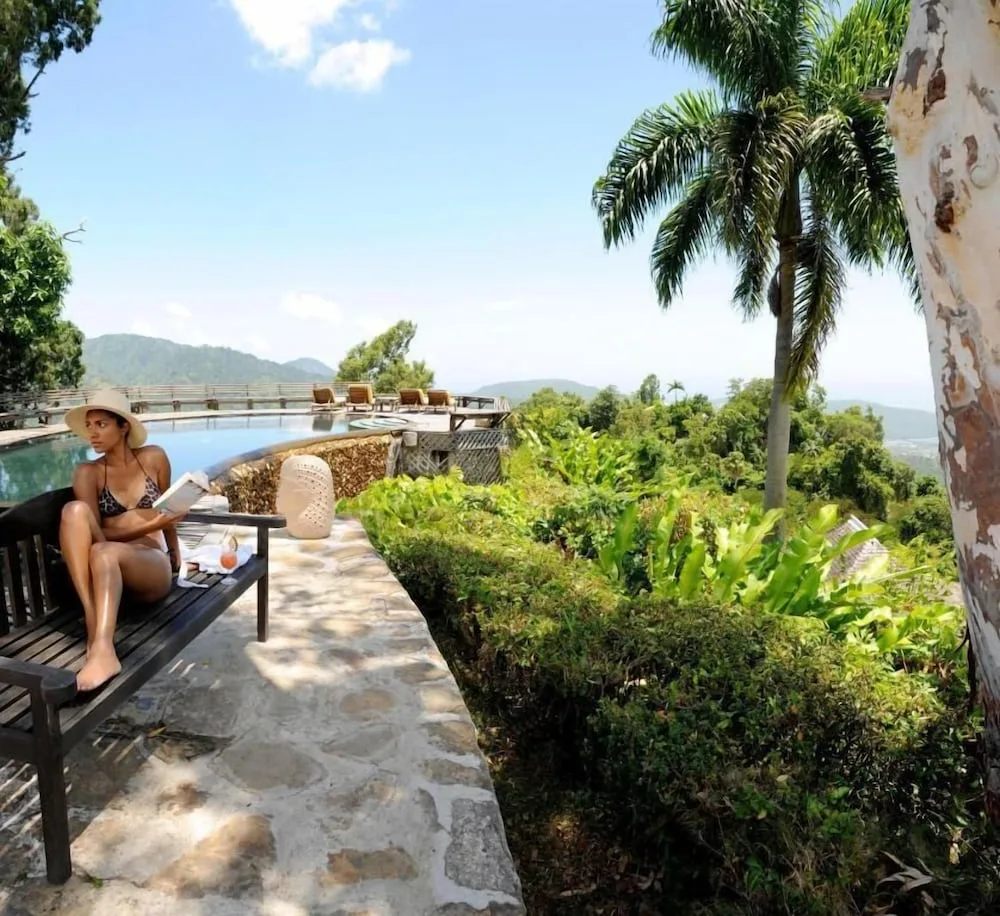 Pool terrace with lounge seating and mountain views at Strawberry Hill.