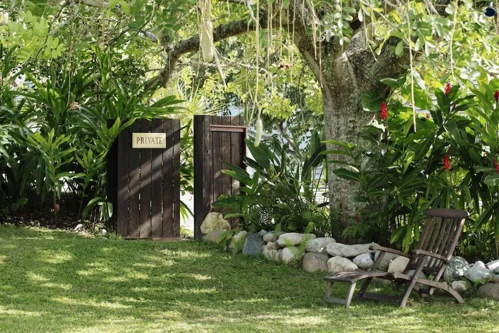 Garden gate marked private beneath a large tree at Strawberry Hill.