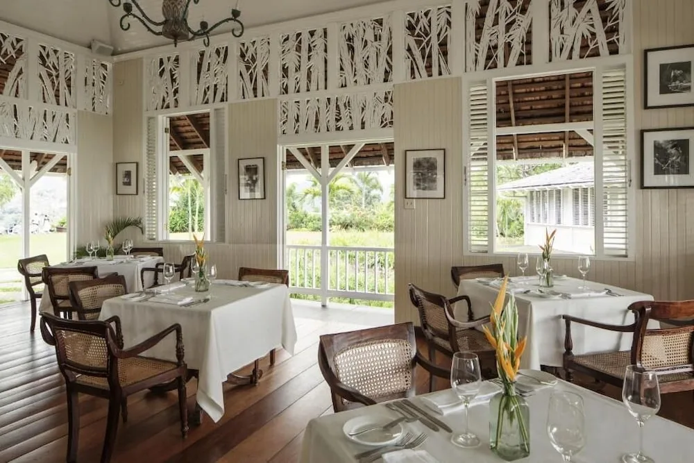 White tablecloth dining room with open shutters at Strawberry Hill.