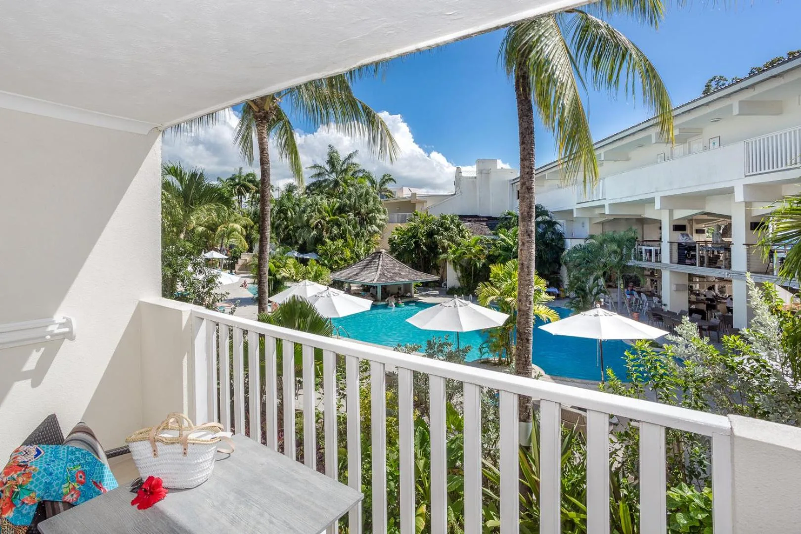 Balcony view over the pool, palms and resort buildings at Sugar Bay Barbados.