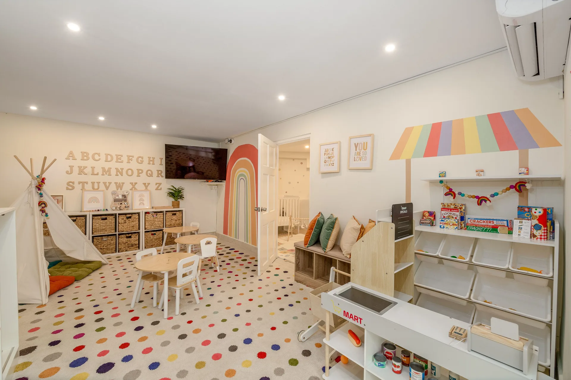 Bright children’s playroom with teepee, small tables and toy market at Sugar Bay Barbados.