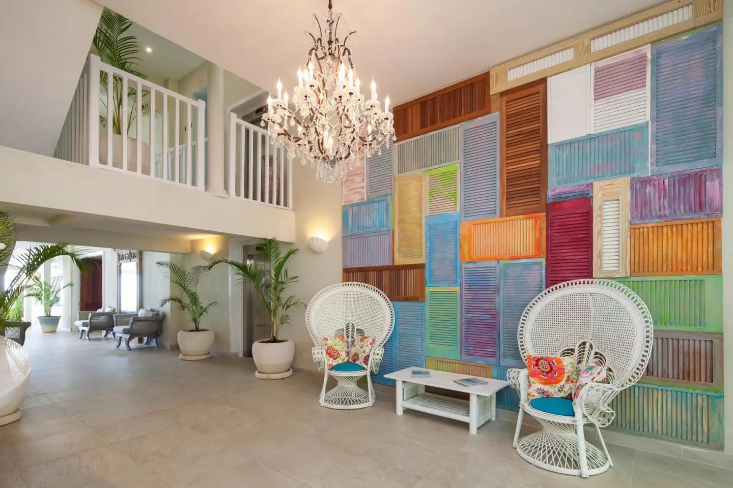 Lobby seating with colorful shutter wall and chandelier at Sugar Bay Barbados.