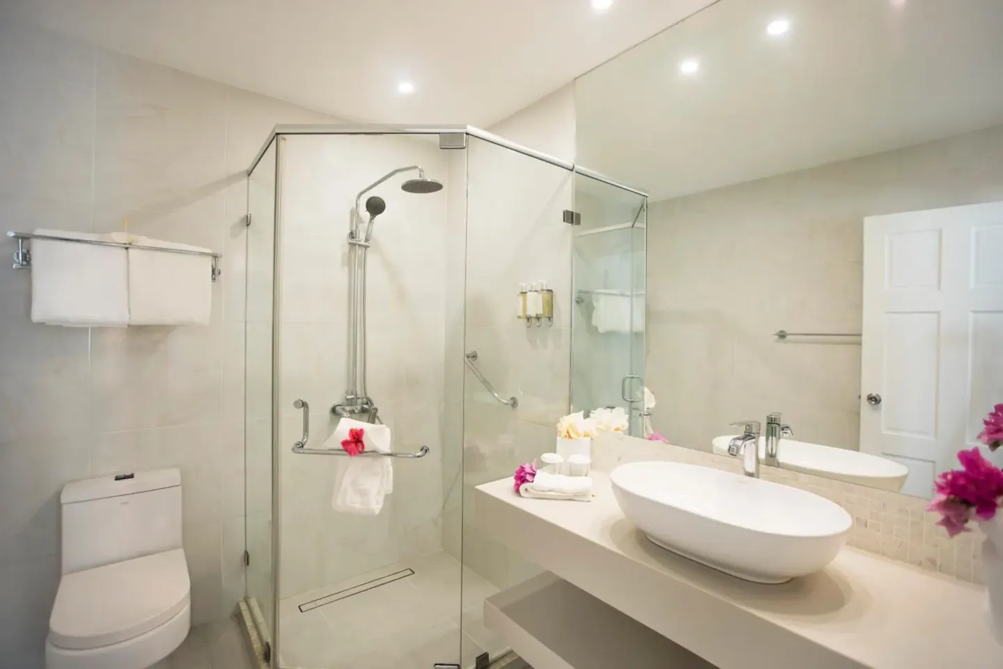 Guest bathroom with glass shower, vessel sink, and towels at Sugar Bay Barbados.