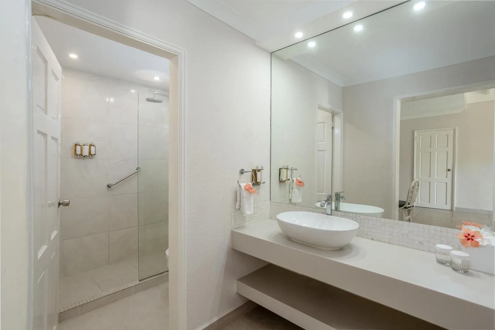 Bathroom vanity and glass shower in a guest room at Sugar Bay Barbados.