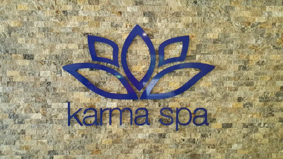 Karma Spa lotus sign on a stone wall at Sugar Bay Barbados.