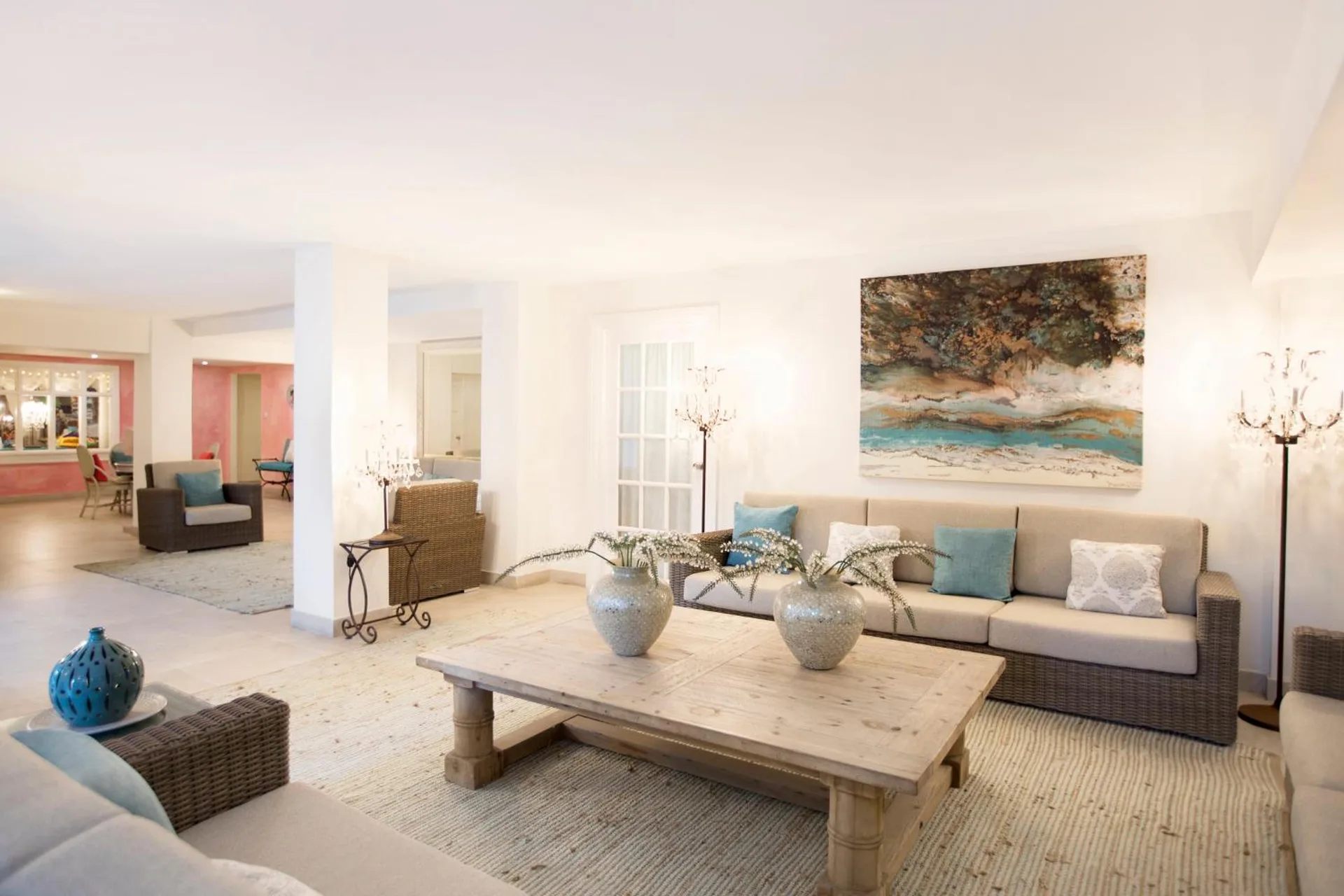 Lobby lounge with sofas, coffee table and coastal artwork at Sugar Bay Barbados.