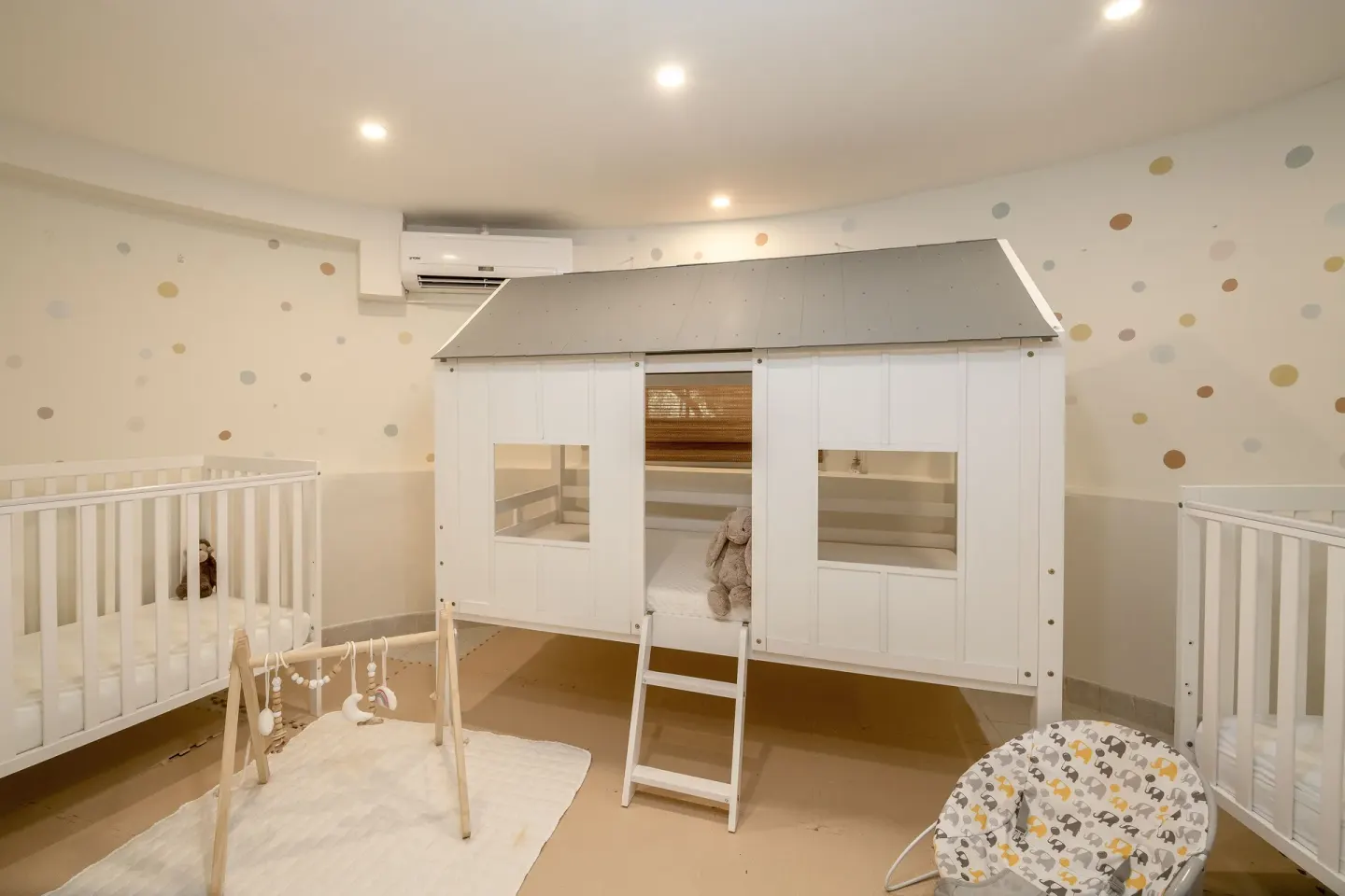 Nursery room with white cribs and a small playhouse loft at Sugar Bay Barbados.