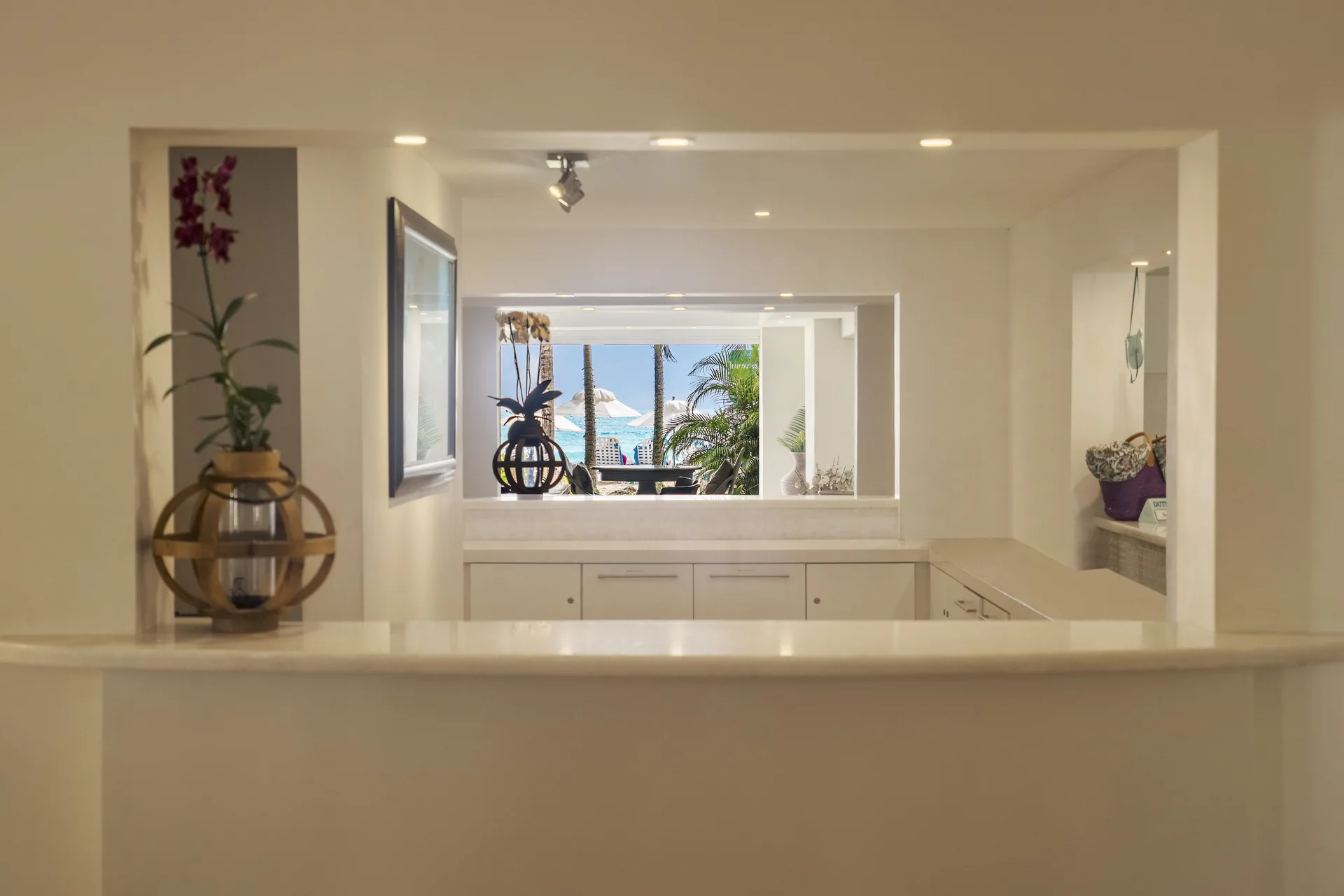 White resort interior with decorative niches and a sea-facing window at Sugar Bay Barbados.