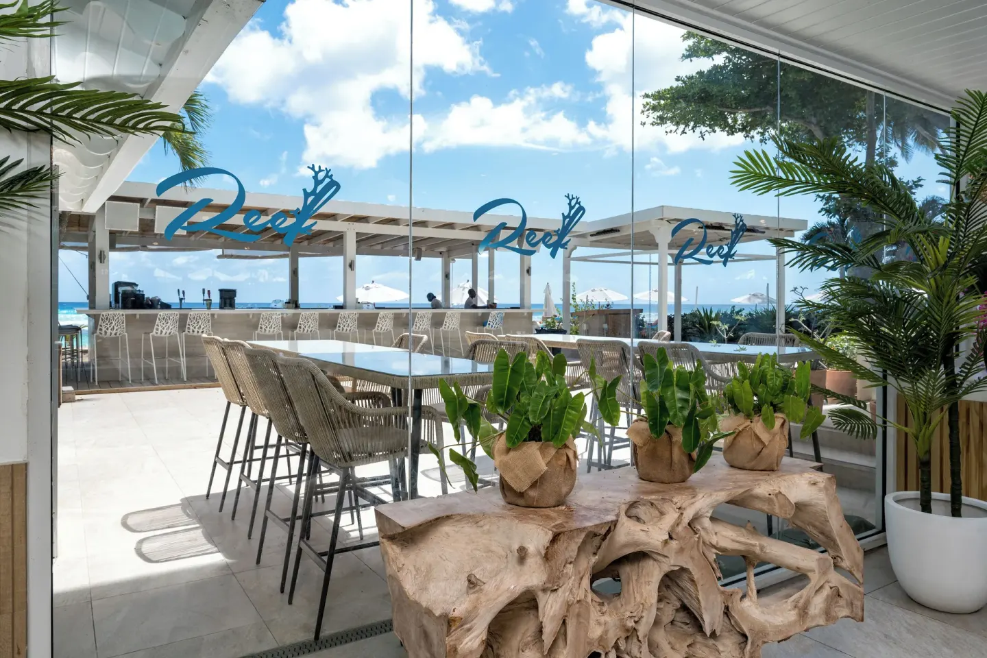 Reef Restaurant glass entrance and ocean-facing seating at Sugar Bay Barbados.