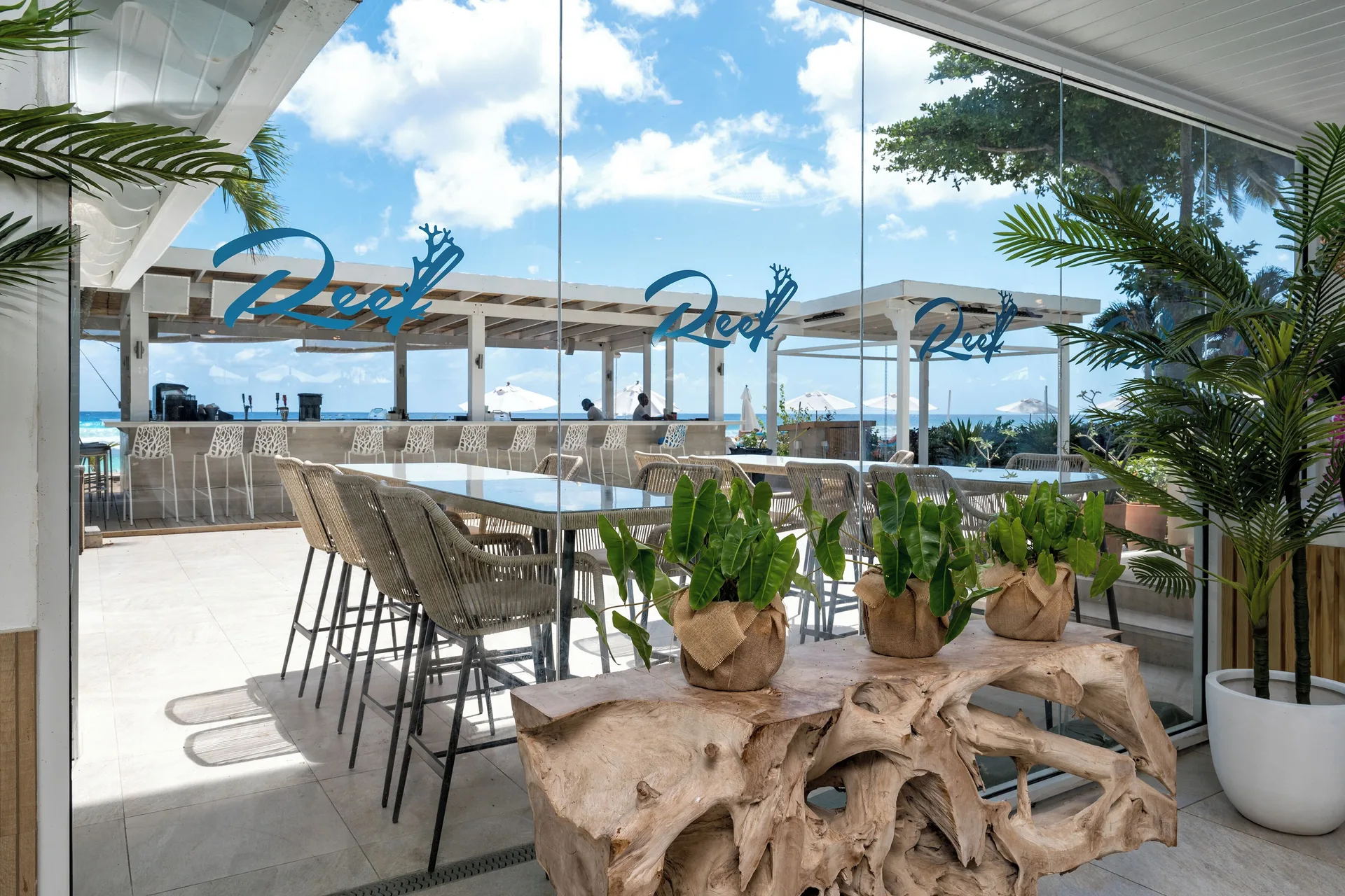 Reef Restaurant glass entrance and ocean-facing seating at Sugar Bay Barbados.