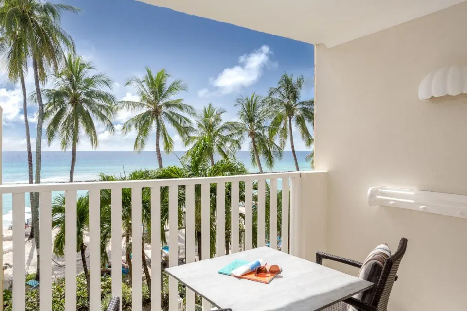 Deluxe Oceanfront Room balcony with palm trees and sea view at Sugar Bay Barbados.