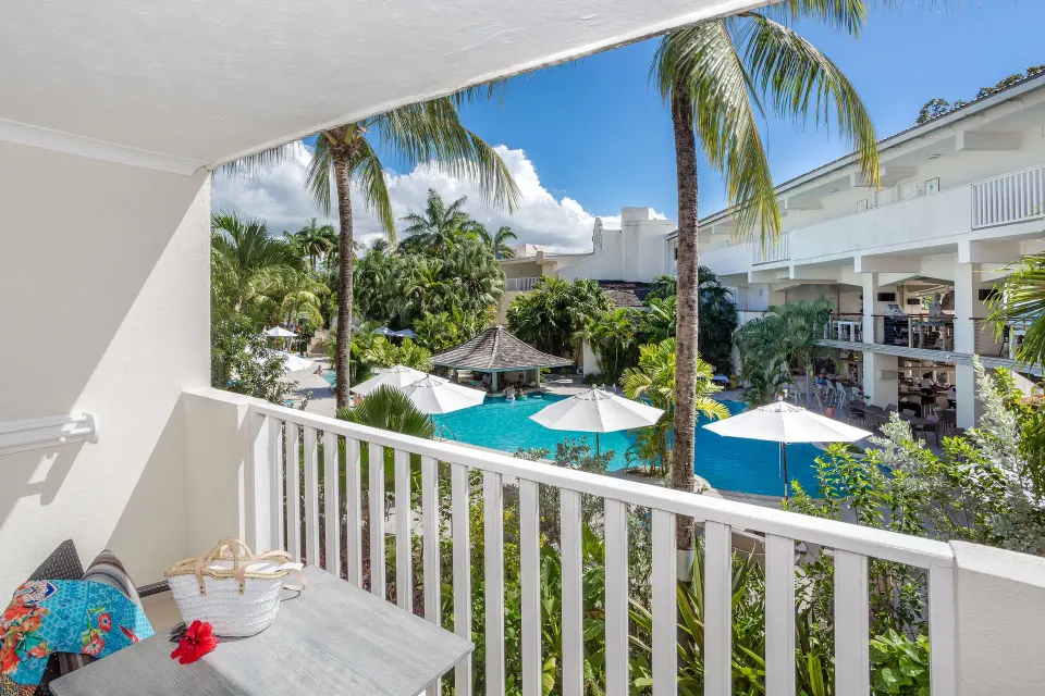 Family Suite Garden View balcony overlooking pool and palms at Sugar Bay Barbados.