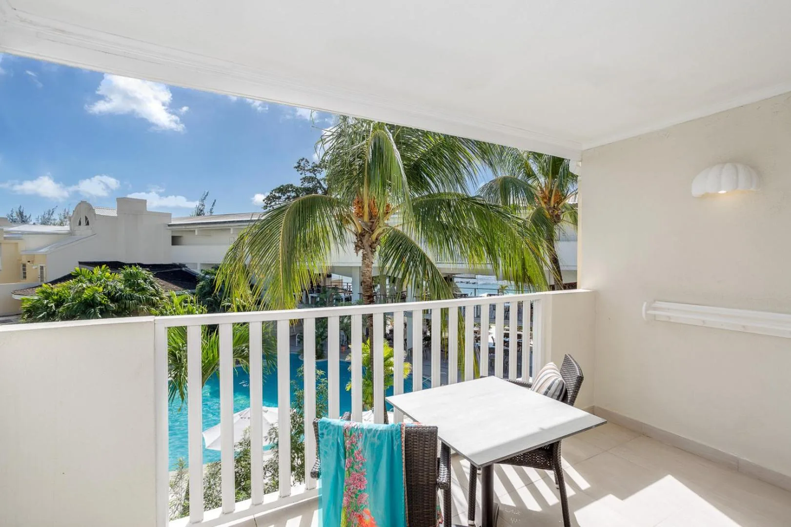Signature room balcony with palm and pool views at Sugar Bay Barbados.
