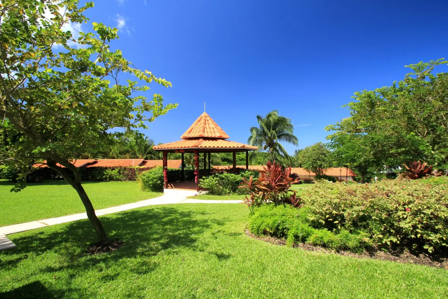 Garden gazebo and curved lawn paths at Sugar Cane Club Hotel And Spa.