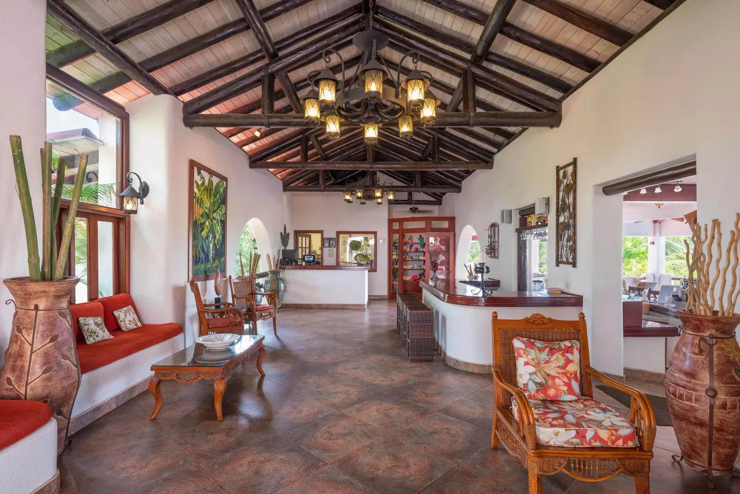 The lobby has vaulted timber beams and wicker seating at Sugar Cane Club Hotel And Spa.
