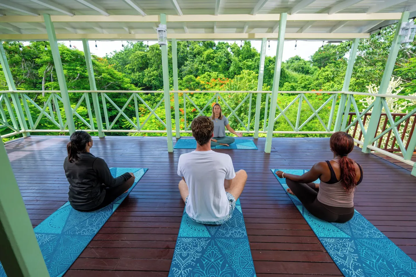 Yoga class on an open-air deck at Sugar Cane Club Hotel And Spa.