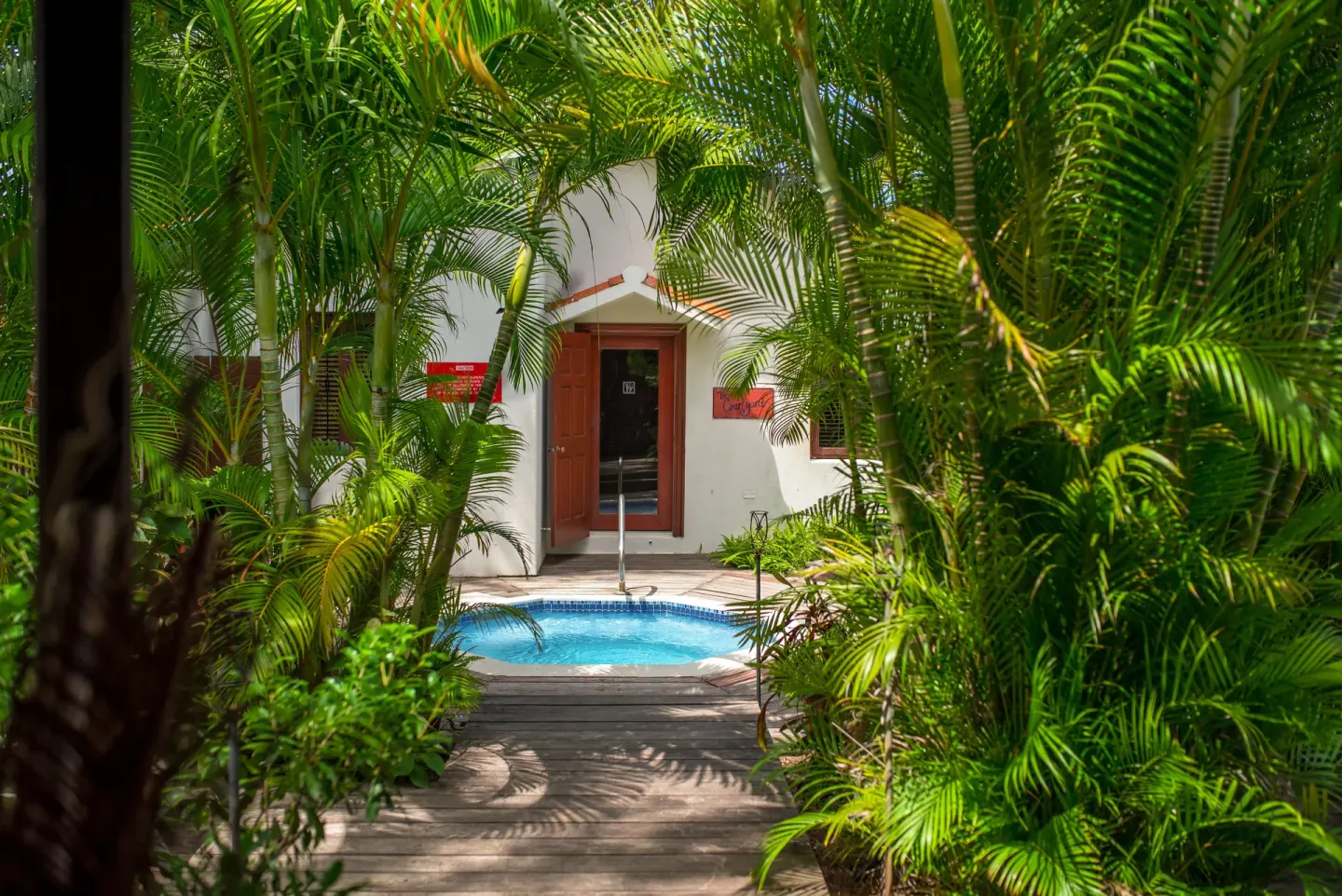 Tropical palms frame a small spa pool at Sugar Cane Club Hotel And Spa.