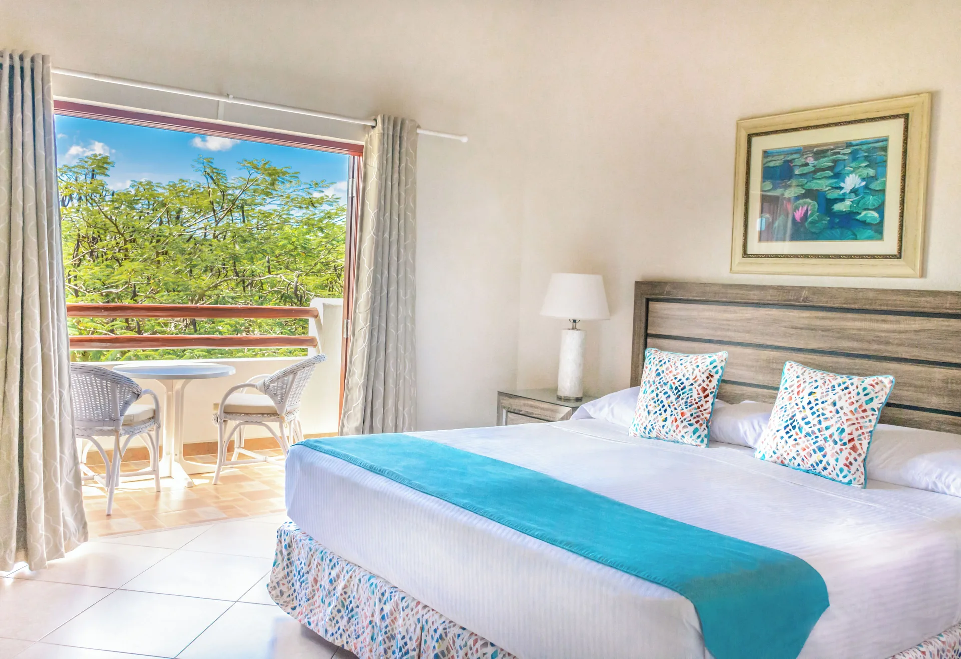 Garden View room with king bed and balcony at Sugar Cane Club Hotel And Spa.