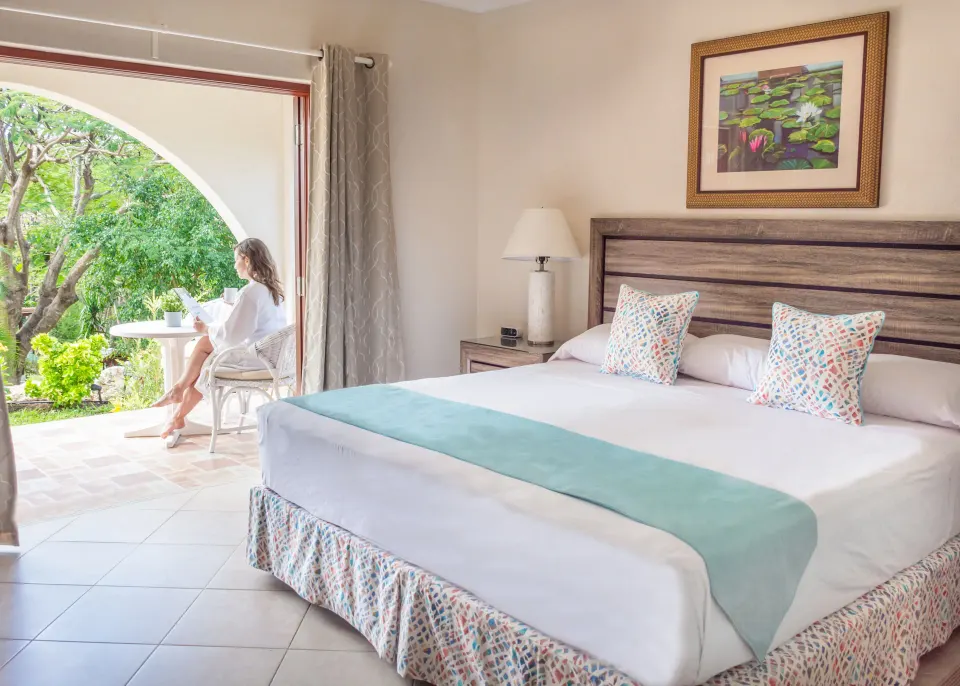 Garden View room with king bed and patio at Sugar Cane Club Hotel And Spa.