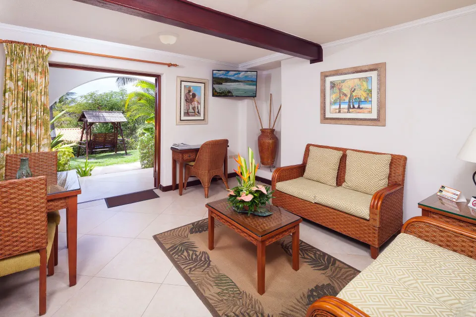 Garden View Suite sitting room opening to a garden patio at Sugar Cane Club Hotel And Spa.