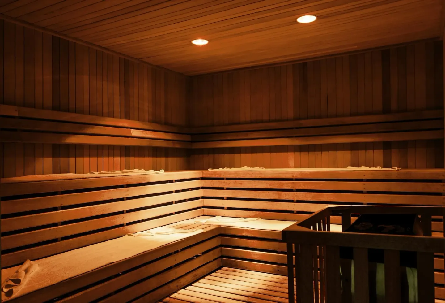 Wood-paneled sauna with benches and warm overhead lights at Sun Palace Cancun.